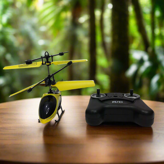 Yellow remote control helicopter with black controller on a white background